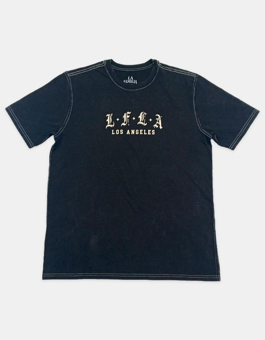 Seven washed black boxy tee front on light gray catalog background